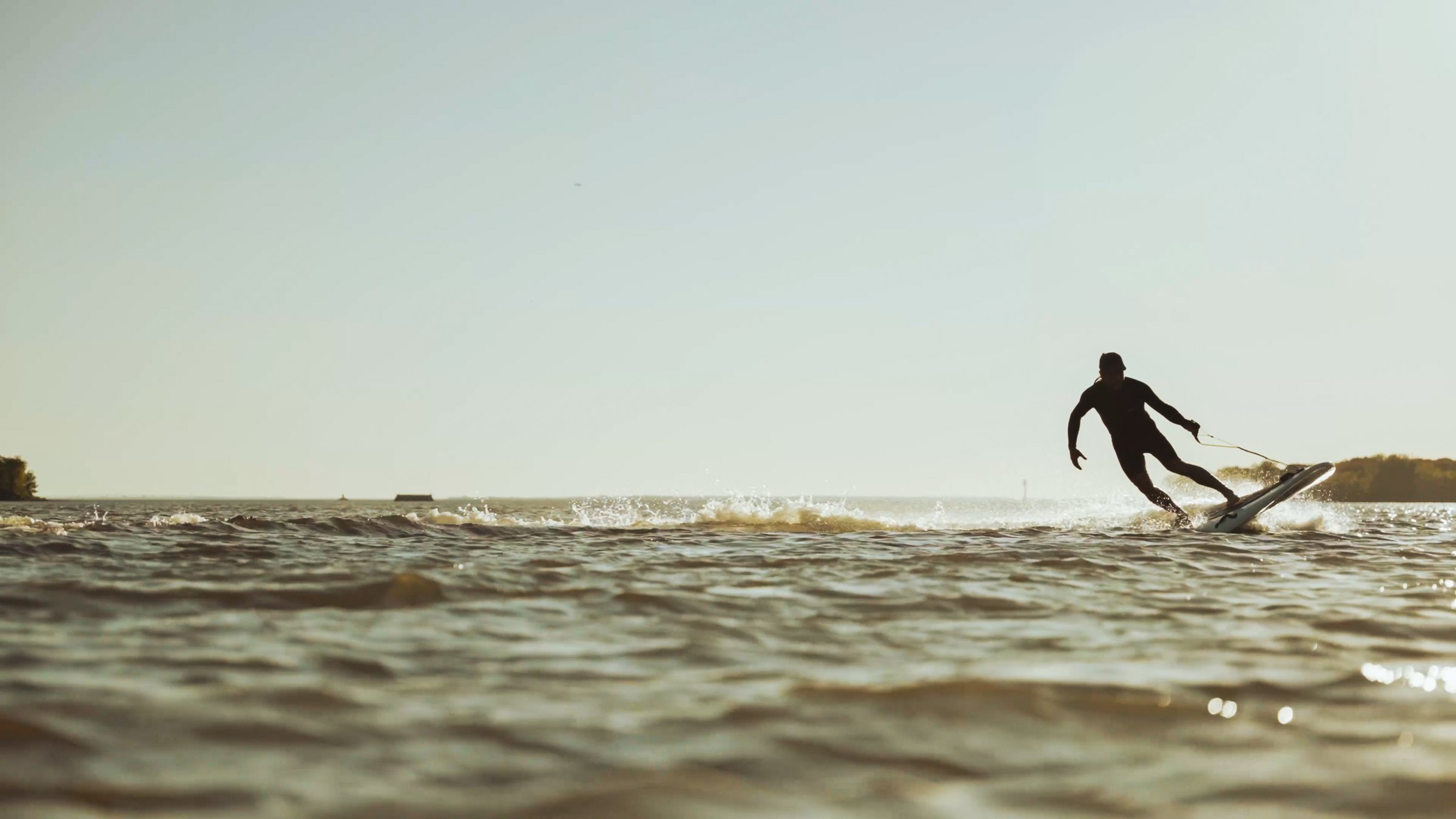 Rider preparing an E-Surf Sport board on the water
